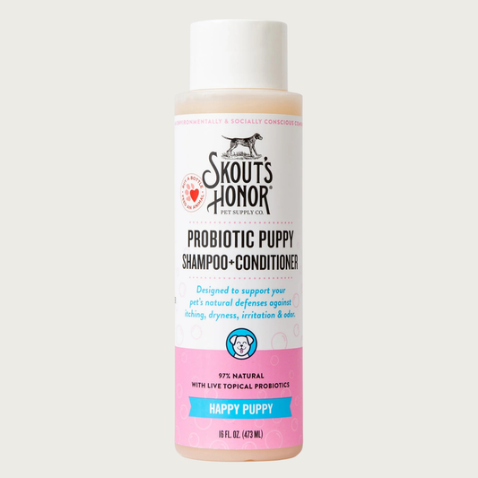 Opaque white plastic bottle of Skout's Honor Probiotic Puppy Shampoo & Conditioner in Happy Puppy. 97% natural with live topical probiotics. Designed to support your pet's natural defenses against itching, dryness, irritation & odor. 16 Fl Oz.