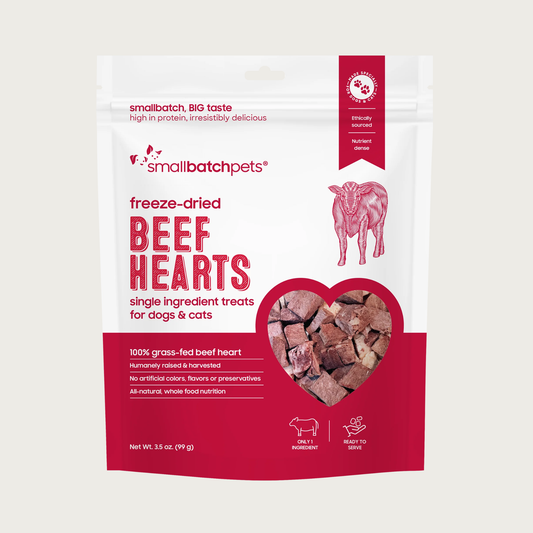 A red and white bag of Smallbatch freeze-dried raw beef heart treats for dogs and cats, 3.5 ounces. This is a single ingredient treat. The bag has a small, clear window showing cubed treat pieces.