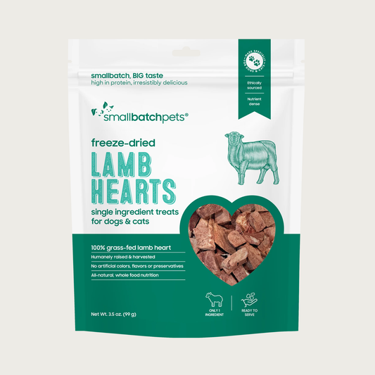A green and white bag of Smallbatch freeze-dried raw lamb heart treats for dogs and cats, 3.5 ounces. This is a single ingredient treat. The bag has a small, clear window showing cubed treat pieces.