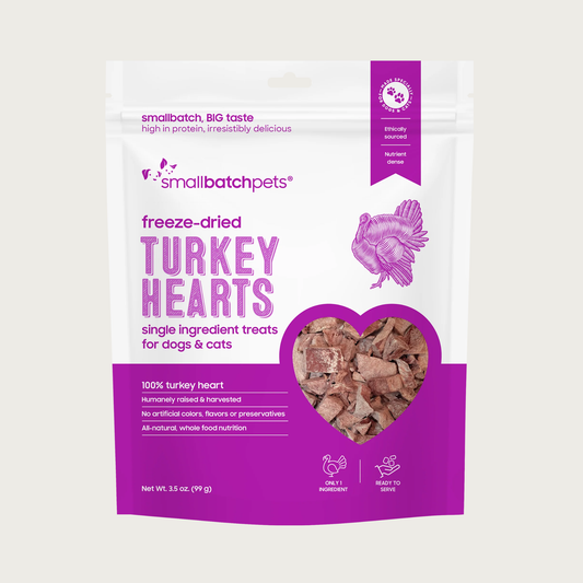 A purple and white bag of Smallbatch freeze-dried raw turkey heart treats for dogs and cats, 3.5 ounces. This is a single ingredient treat. The bag has a small, clear window showing cubed treat pieces.