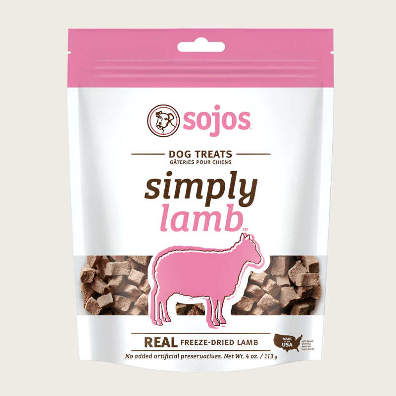 A 4 oz white and pink bag of Sojos Simply Lamb Dog Treats. Made with real freeze-dried lamb. No added artificial preservatives. See-through window at the bottom of the bag shows product inside - very small, cube shaped brown treats.