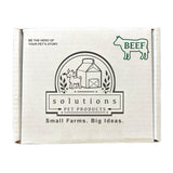 Plain white cardboard box, with text that reads: Be the hero of your pet's story. Center logo says Solutions Pet Products, Small Farms. Big Ideas. Outline of a cow in the top right corner, with BEEF written inside it.