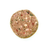 A close-up view of a Solutions Pet Products slider, that is light reddish brown in color. Pieces of green vegetables, small chunks of meat and either bone or fat are visible.
