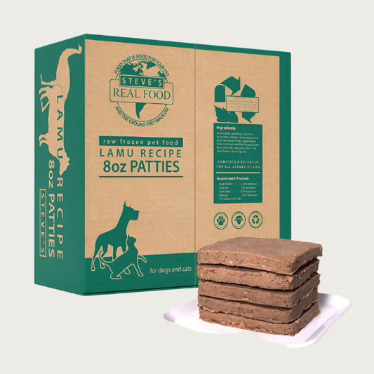 A 14 pound box of Steve's Real Food frozen raw food 8 ounce patties in the lamu (lamb and emu) recipe for both dogs and cats. A plate of the bar shaped patties is positioned in front of the box for reference.