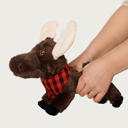 Moose dog toy being squeezed by a pair of hands, to make its antlers stand up.