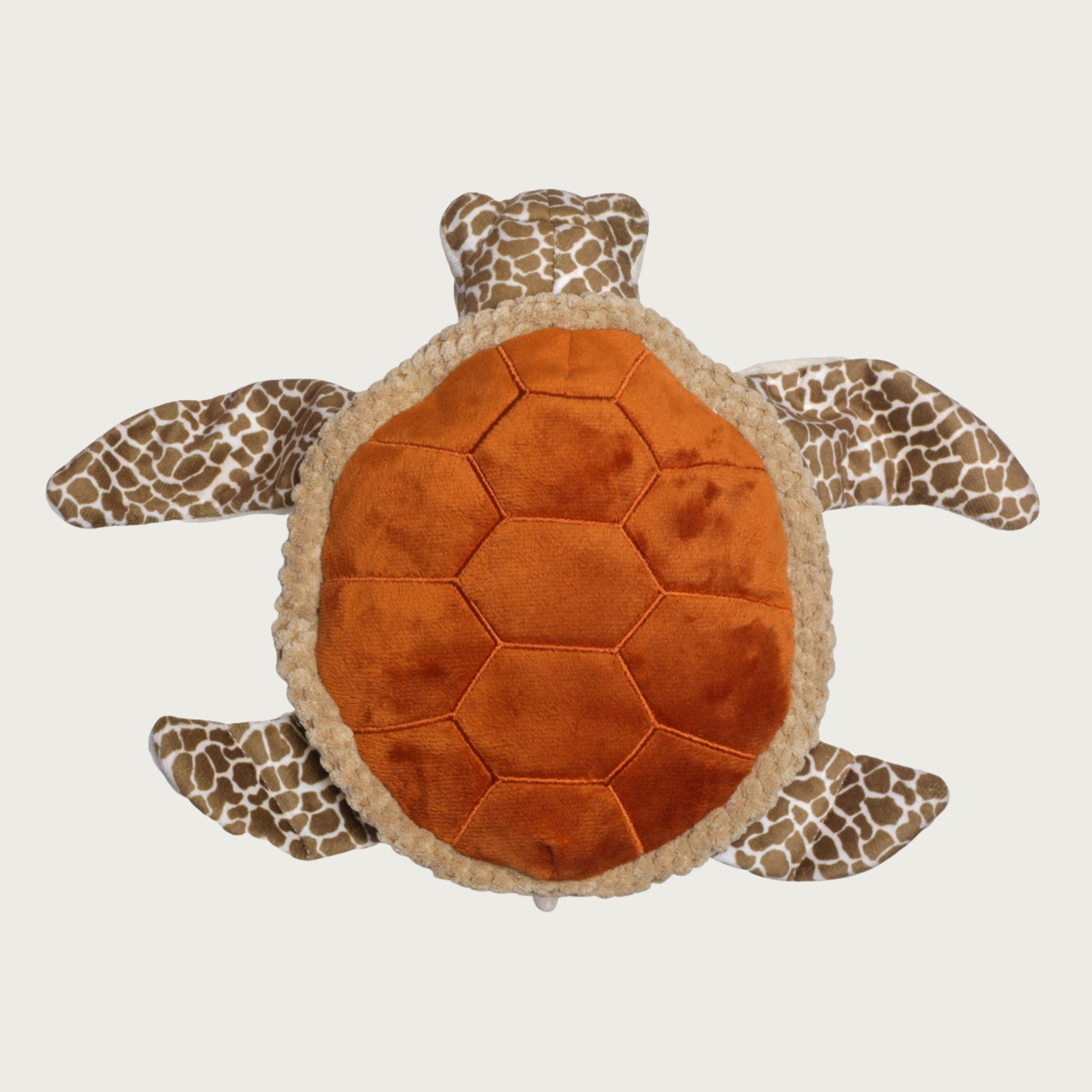Plush sea turtle dog toy viewed from above, featuring a textured orange-brown stitched shell and patterned brown-and-beige flippers and head.