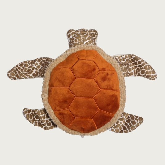 Plush sea turtle dog toy viewed from above, featuring a textured orange-brown stitched shell and patterned brown-and-beige flippers and head.