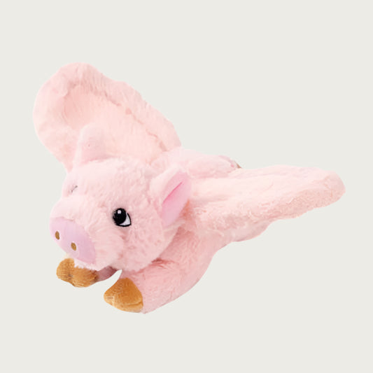 A pale pink, plush pig toy with wings. The pig's face has embroidered eyes and a snout.