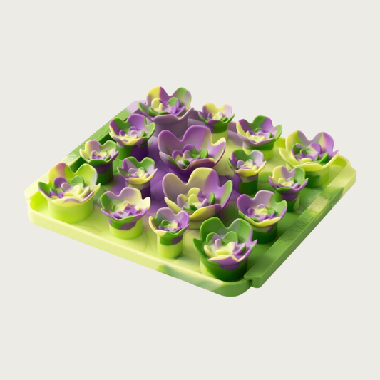 Photo of the Tall Tails Foraging Mat in Succulent Garden design. It is bright green & purple, square, with four tightly packed rows of raised, succulent plant shapes, each about 1"-2.5" wide.