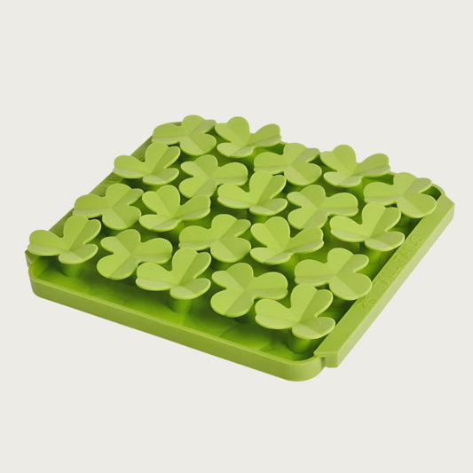Photo of the Tall Tails Foraging Mat in Clover design. It is grass green, square, with four tightly packed rows of raised, 3-leaf clover shapes, each about 1"-2" wide.