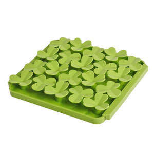 Photo of the Tall Tails Foraging Mat in Clover design. It is grass green, square, with four tightly packed rows of raised, 3-leaf clover shapes, each about 1"-2" wide.