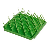 Photo of the Tall Tails Foraging Mat in Grass design. It is a bright green square with diagonal rows of dual-bladed silicone "grass".