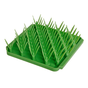Photo of the Tall Tails Foraging Mat in Grass design. It is a bright green square with diagonal rows of dual-bladed silicone "grass".