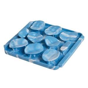 Photo of the Tall Tails Foraging Mat in Rock design. It is sky blue marbled with white, square, with three rows of raised, irregular circles, each about 2" wide.
