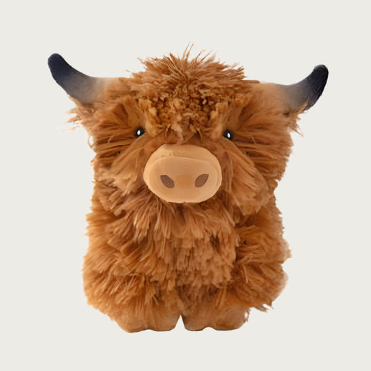 A cute highland cow dog toy, with horns, snout and feet. Covered in caramel colored shaggy plush fabric.