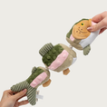 Load image into Gallery viewer, Alternate view of the Jointed Shake Play Trout dog toy, with hands stretching it out on each end.
