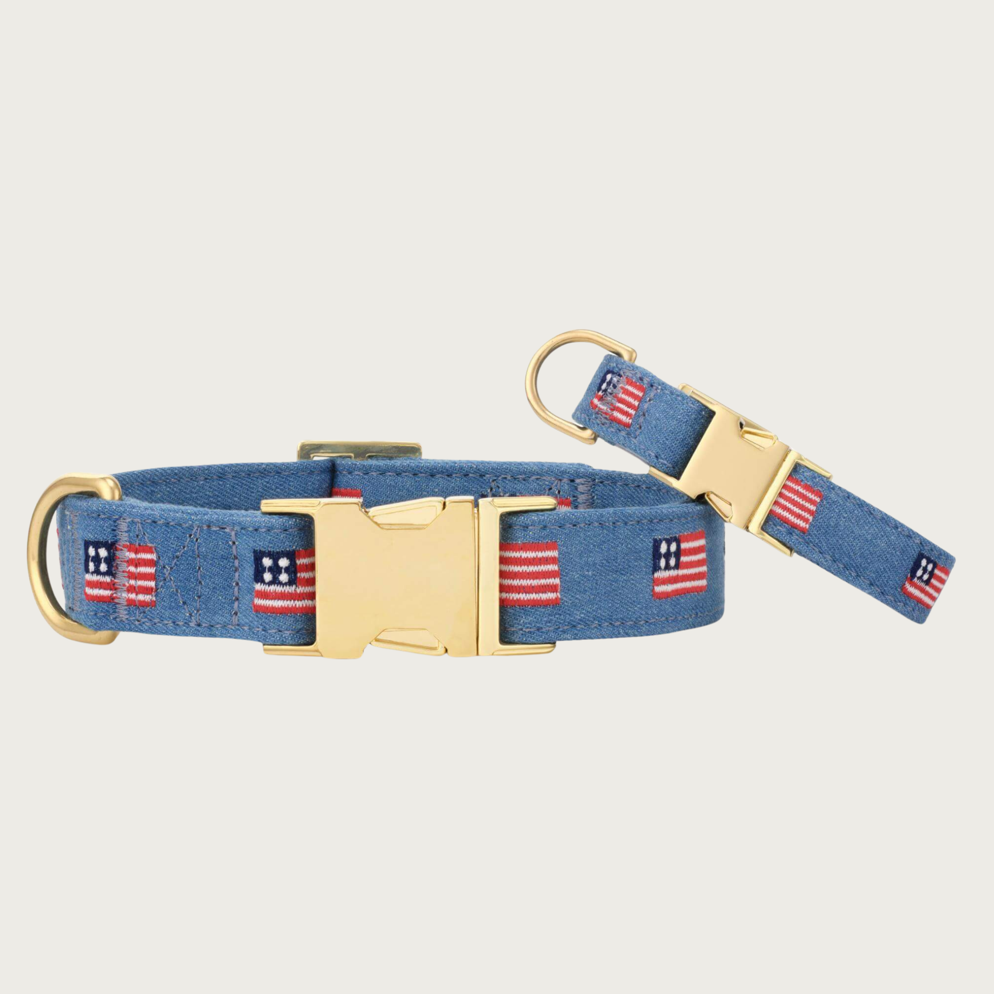 Two American Flag Embroidered dog collars with different widths (5/8" and 1"), with the smaller & more narrow collar leaning on the larger one.