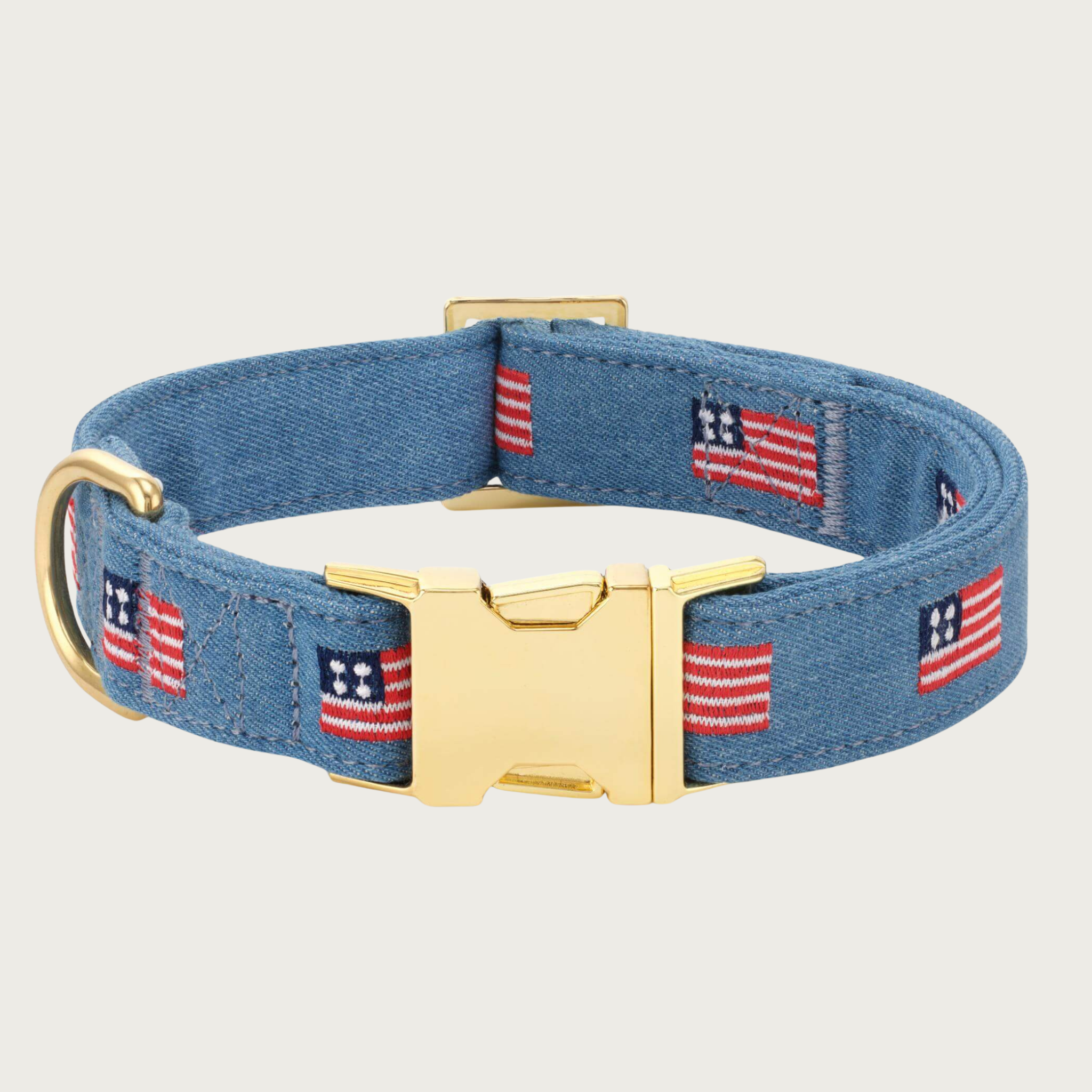 Medium blue denim dog collar with embroidered American flags, evenly spaced along the center of the collar, with gold-toned hardware.