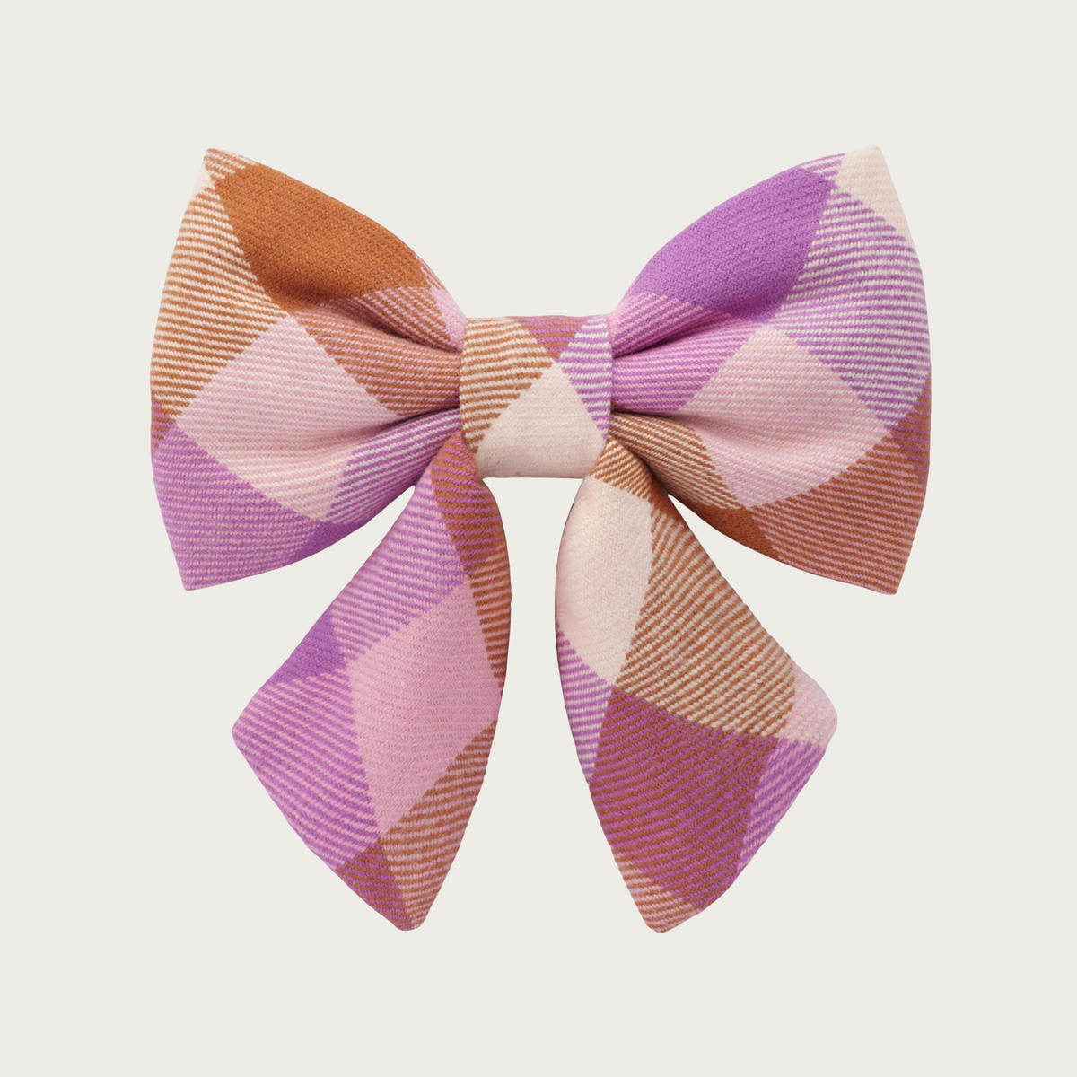 Plaid flannel lady bow tie for dogs, in shades of rust brown, medium purple, and cream. Looks like a hair bow for a person, with the center bow tie and ends hanging down.