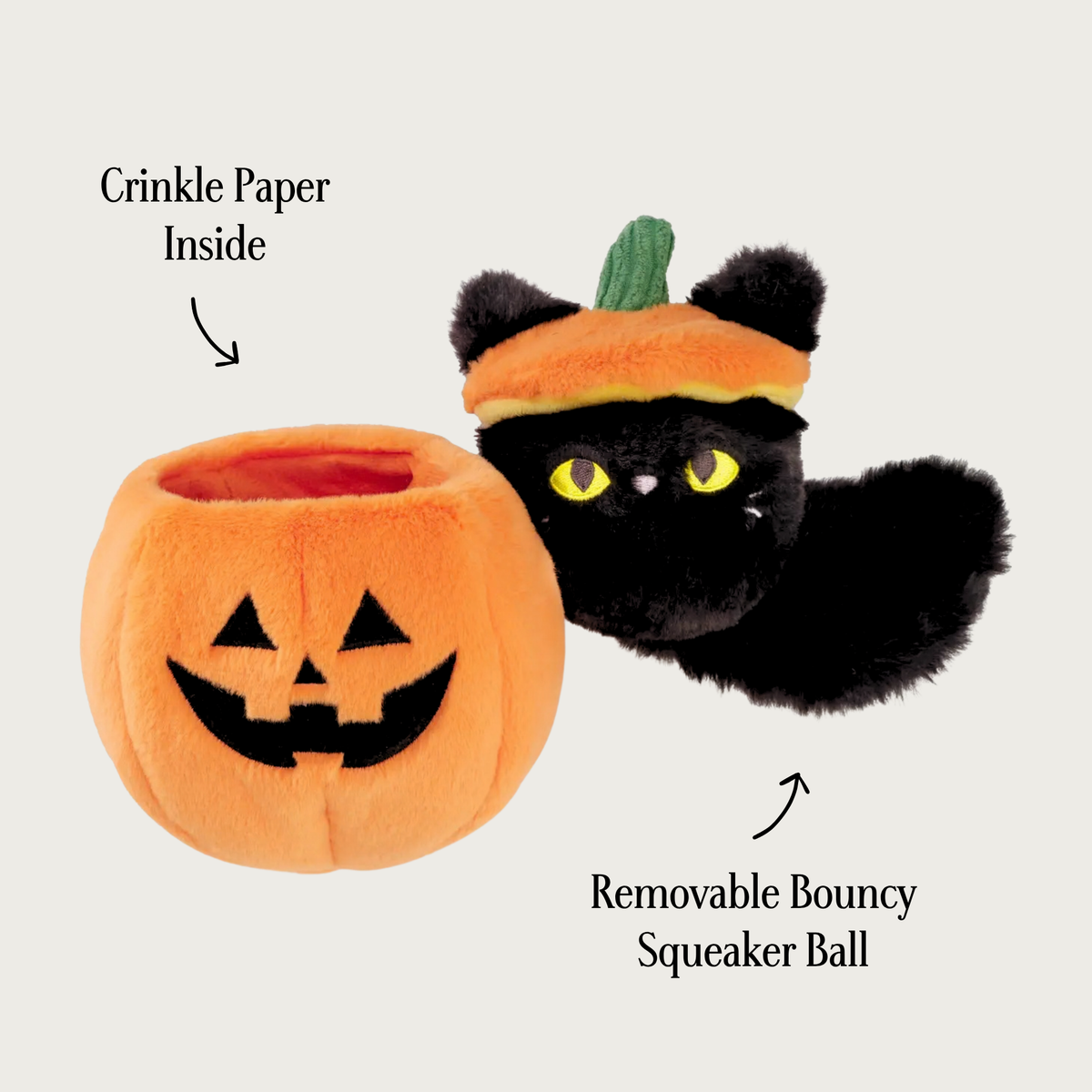 Cat-o'-Lantern dog toy, opened up to reveal the plush covered black cat squeaky ball with a fluffy black tail and yellow embroidered eyes, wearing the pumpkin top on its head. The open jack-o-lantern part of the toy is next to it. Text labels indicate 'Crinkle Paper Inside' and 'Removable Bouncy Squeaker Ball'.