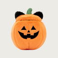 Load image into Gallery viewer, An orange plush pumpkin dog toy with a embroidered black jack-o'-lantern face, black fuzzy cat ears on its removable lid, with a small green stem between the ears.
