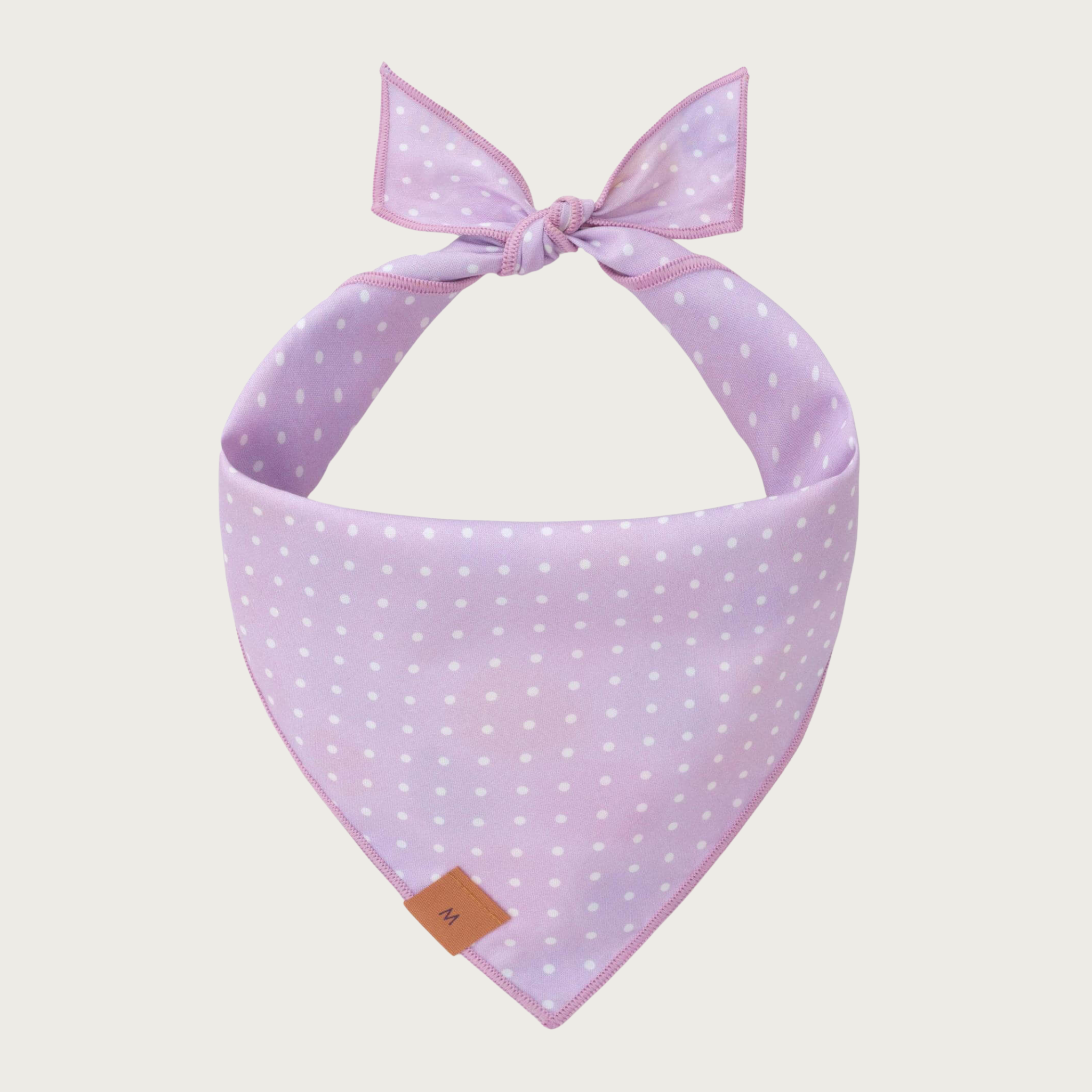 Reverse side of the Easter Eggs dog bandana. It is pale lilac in color with tiny white polka dots.
