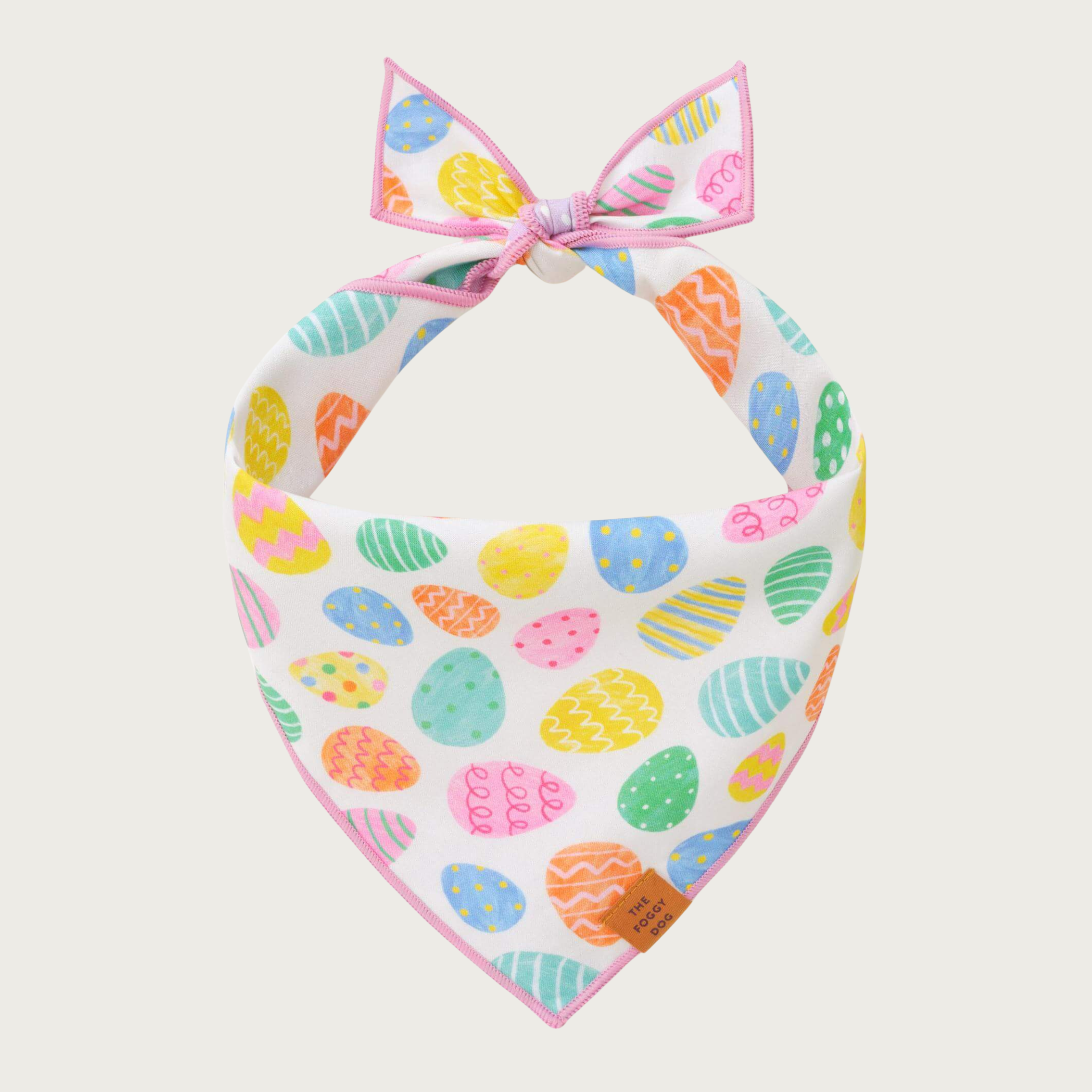 Dog bandana featuring a pastel multi-colored Easter egg print on a cream background.