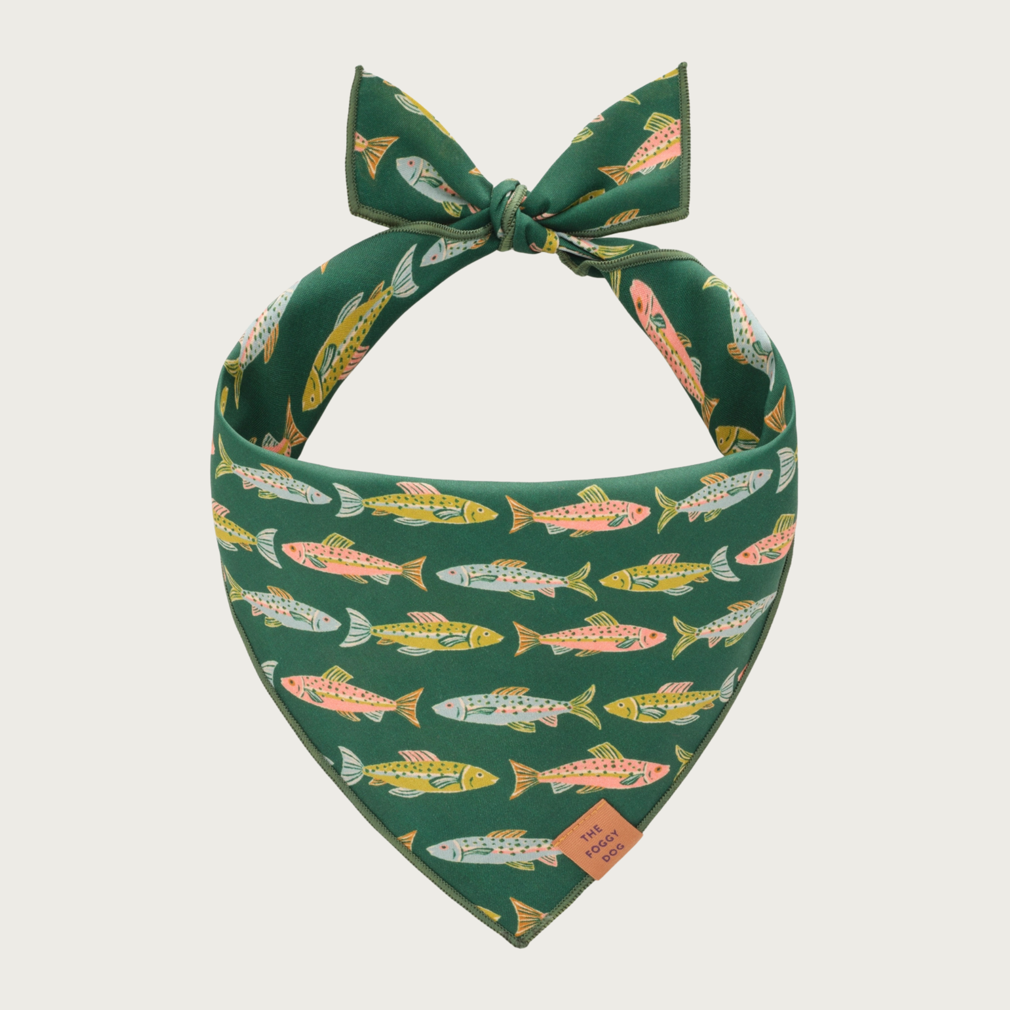 Pine green dog bandana with pastel-hued fish pattern.