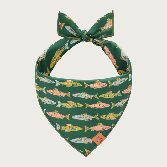 Pine green dog bandana with pastel-hued fish pattern.