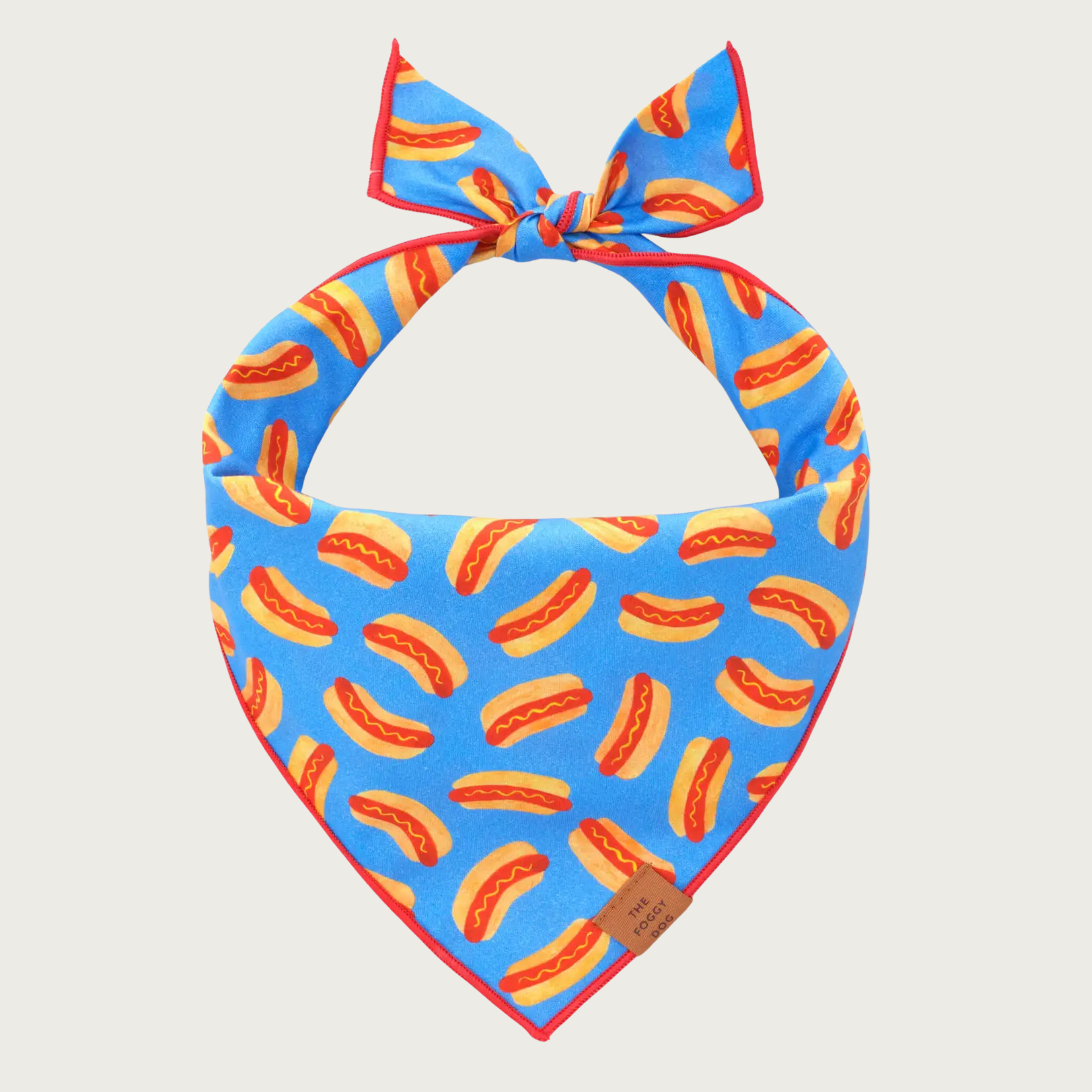 Dog bandana with red & yellow hot dog print on a bright, medium blue background.