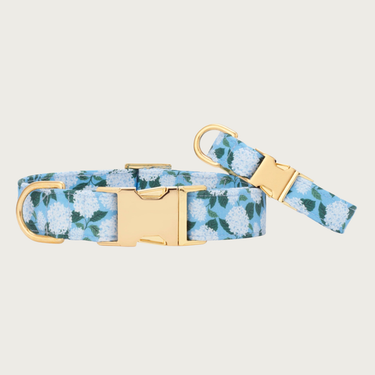 Two Hydrangea dog collars with different widths (5/8" and 1"), with the smaller & more narrow collar leaning on the larger one.
