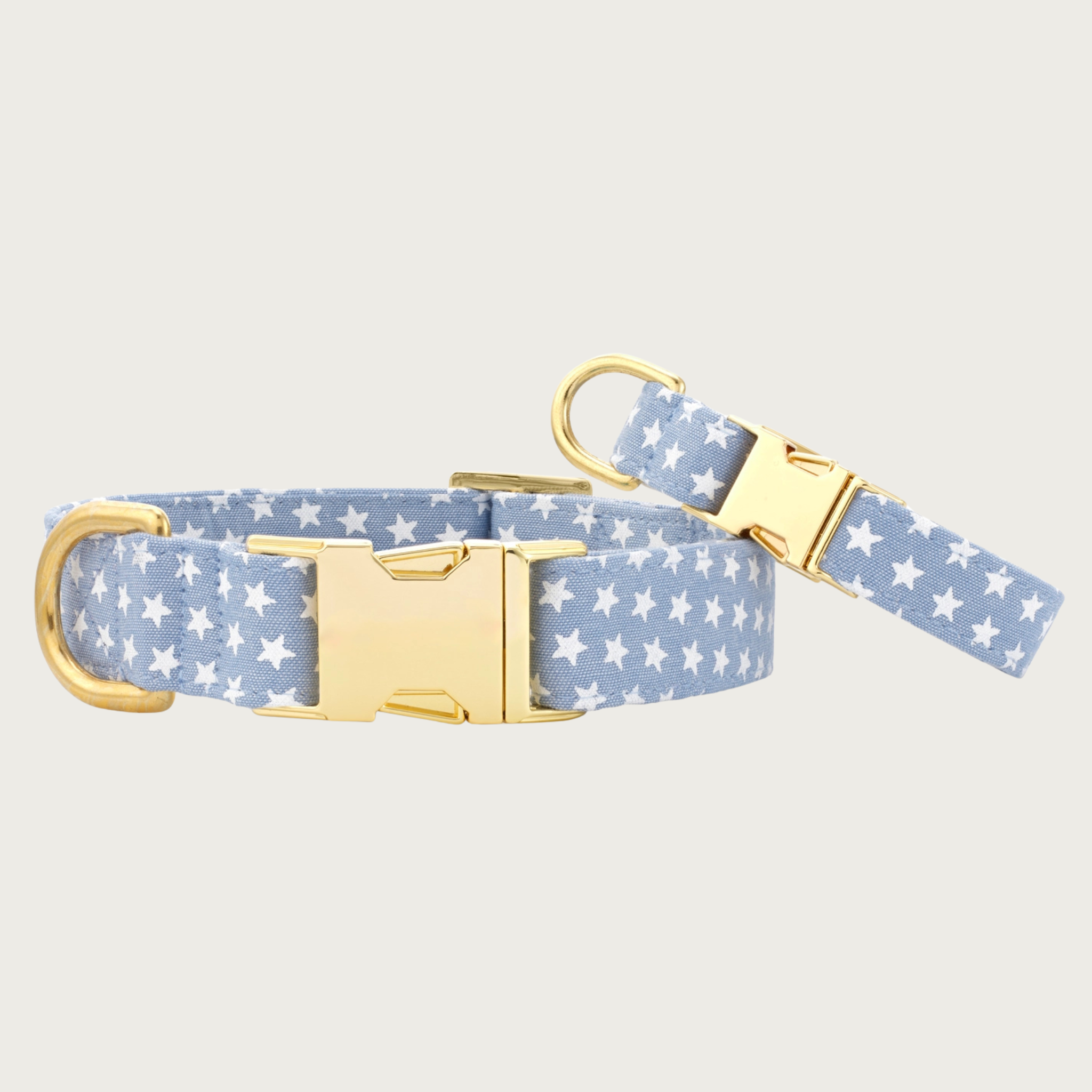 Two Liberty dog collars with different widths (5/8" and 1"), with the smaller & more narrow collar leaning on the larger one.