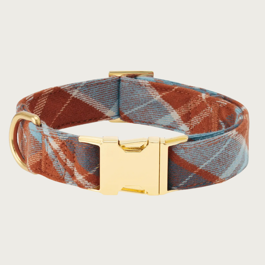 A plaid flannel dog collar with a russet brown, grayish blue, and cream plaid pattern, with polished gold-tone buckle & hardware.