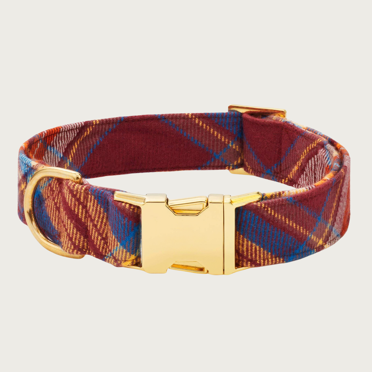 A plaid flannel dog collar with a rust, medium blue, and gold plaid pattern, with polished gold-tone buckle & hardware.