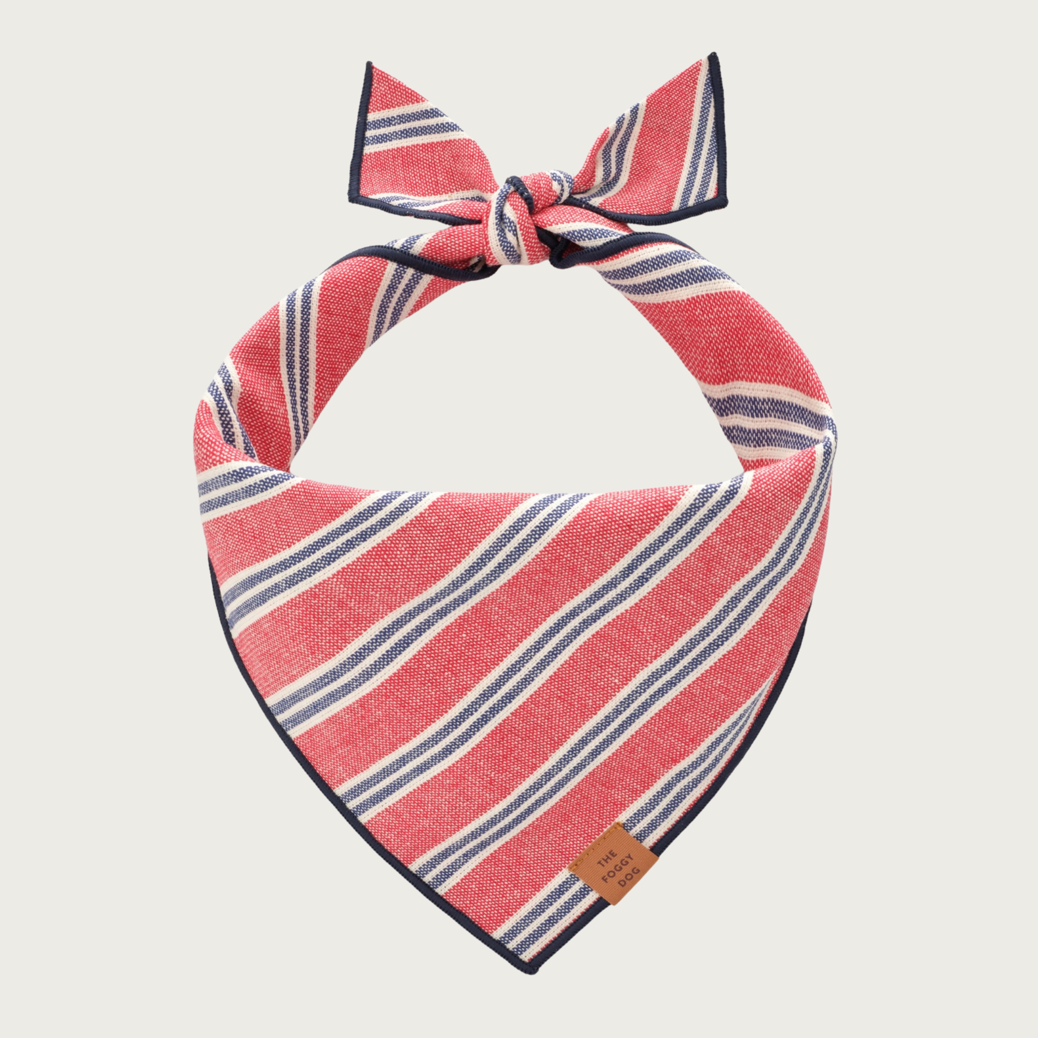 Oxford cloth pale red dog bandana with grouped, white and muted navy blue diagonal stripes.