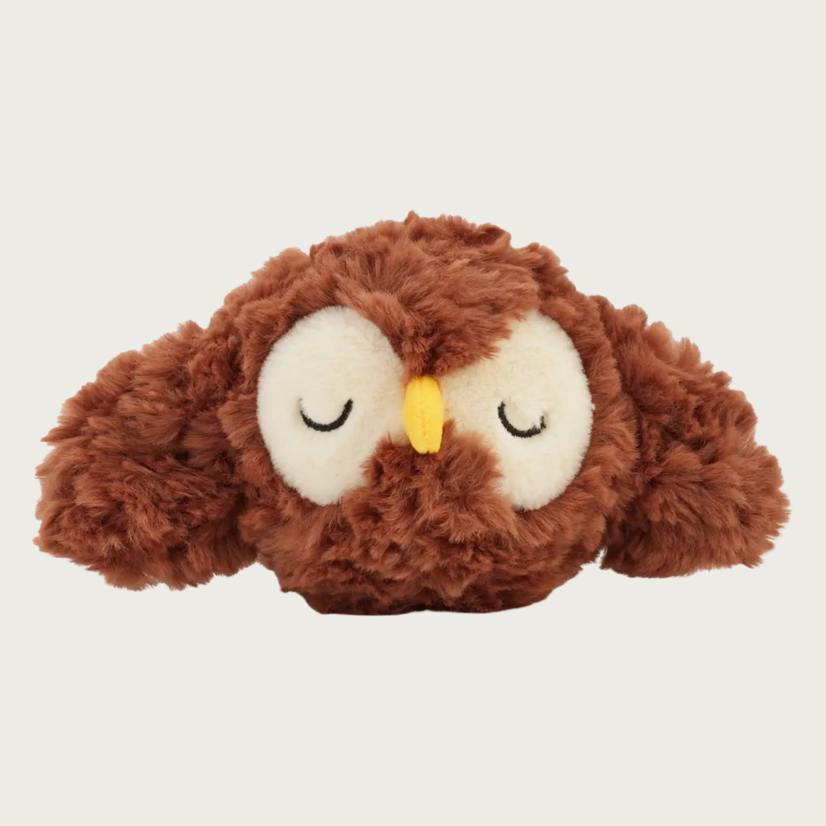 A brown, fluffy, plush owl dog toy ball, with cream-colored eye area with embroidered closed eyes, and a small yellow beak.