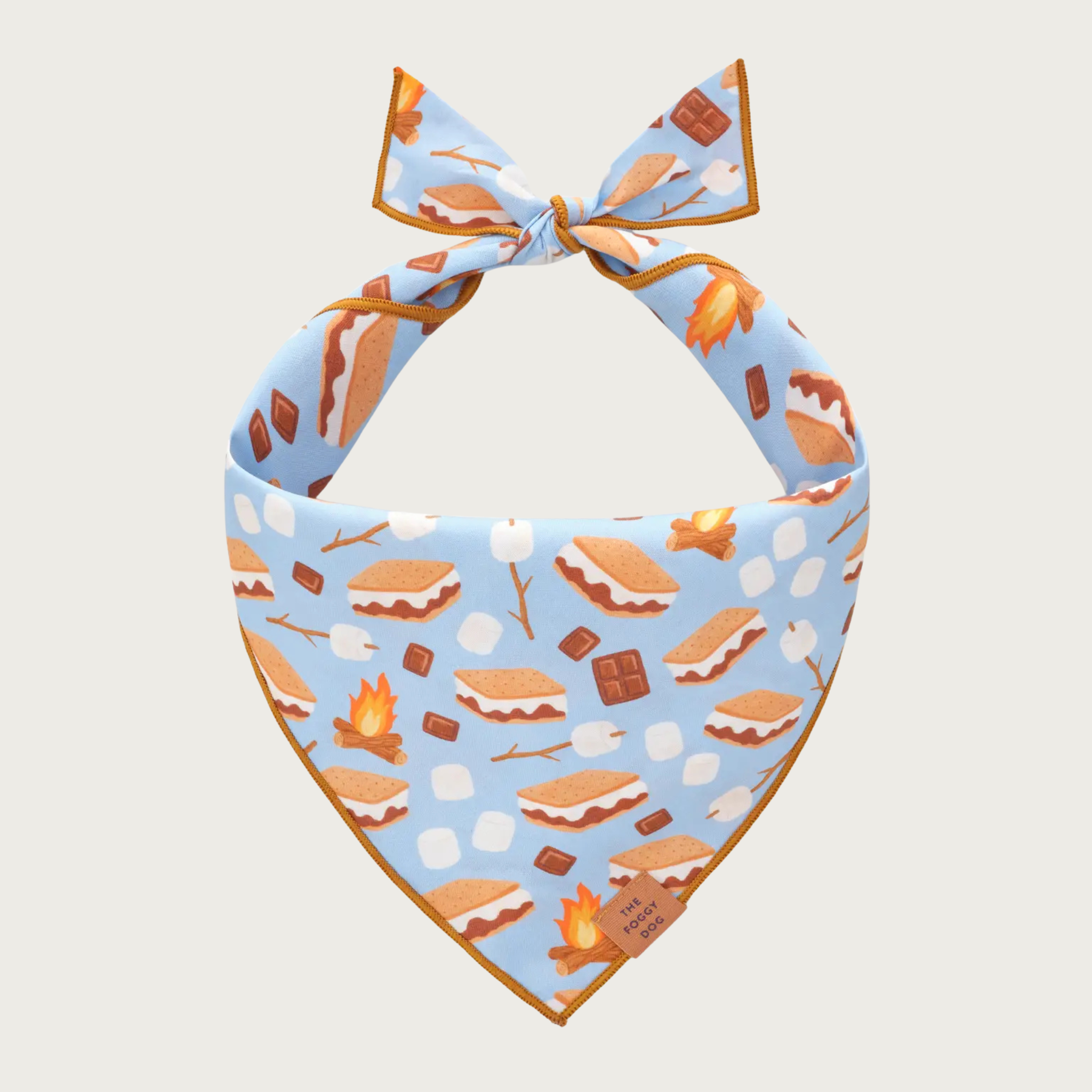 Dog bandana with s'mores pattern on a light blue background. The pattern includes illustrated campfires, loose marshmallows, marshmallows on a stick, chocolate bars, and fully assembled s'mores.