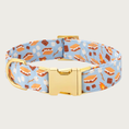 Load image into Gallery viewer, Dog collar with s'mores pattern on a light blue background. The pattern includes illustrated campfires, loose marshmallows, marshmallows on a stick, chocolate bars, and fully assembled s'mores. Features gold-toned hardware.
