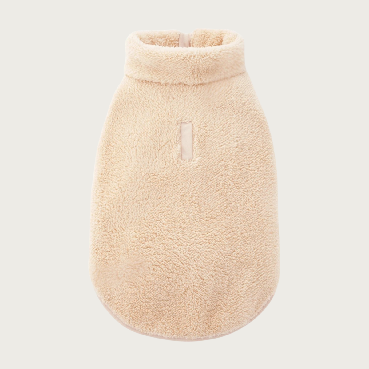 A beige, plush sherpa fleece pet jacket featuring a high collar and a small leash opening on the back.