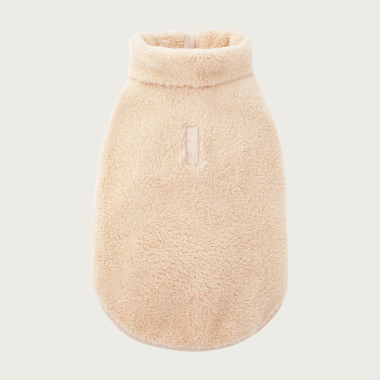 A beige, plush sherpa fleece pet jacket featuring a high collar and a small leash opening on the back.
