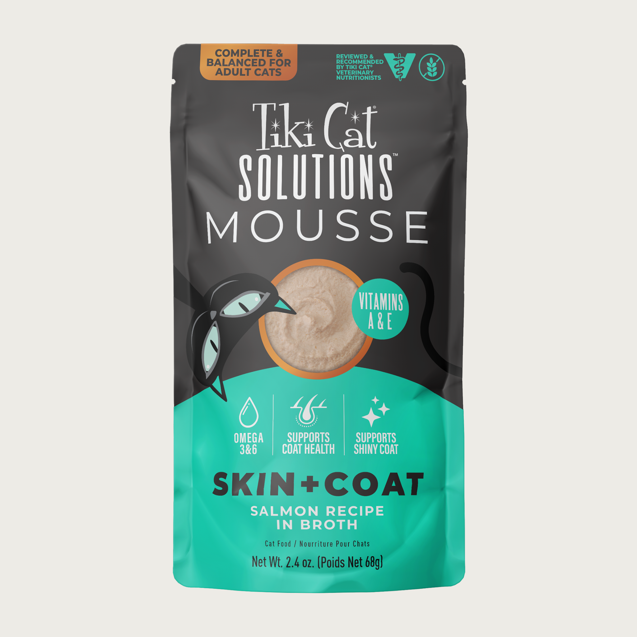 A 2.4 oz aqua & black pouch of Tiki Cat Solutions Mousse Skin & Coat - Salmon Recipe in Broth. Text highlights: Omega 3 & 6, Supports Coat Health, Supports Shiny Coat. Complete & Balanced for Adult Cats. Reviewed & recommended by Tiki Cat Veterinary Nutritionists.