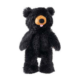 A full body black bear dog toy. It is covered in shaggy black plush, with a tan muzzle, black nose, and pink tongue playfully sticking out of the bear's mouth.