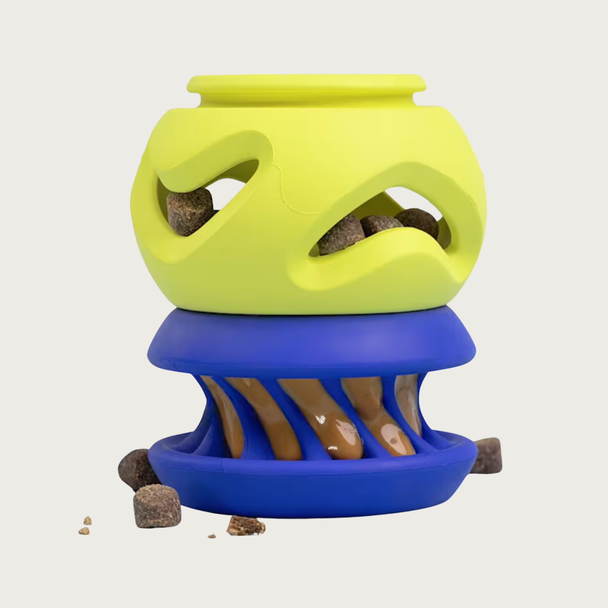A two-piece rubber dog toy consisting of a bright lime green top section (The Boomerang) connected to a royal blue bottom section (The Slobber).