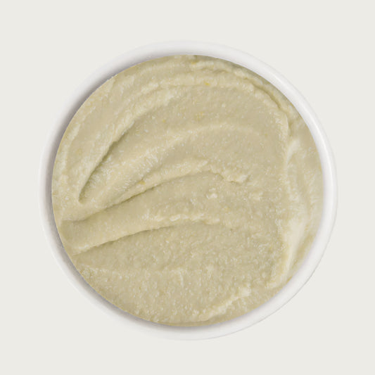 A close-up image of a dish of Weruva Wx Phos Focused Chicken Formula in a Hydrating Puree. It is a very smooth, beige colored puree.