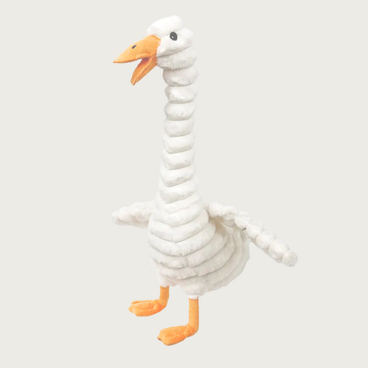 Plush duck dog toy with thick white corduroy body, orange beak and feet and embroidered facial details.