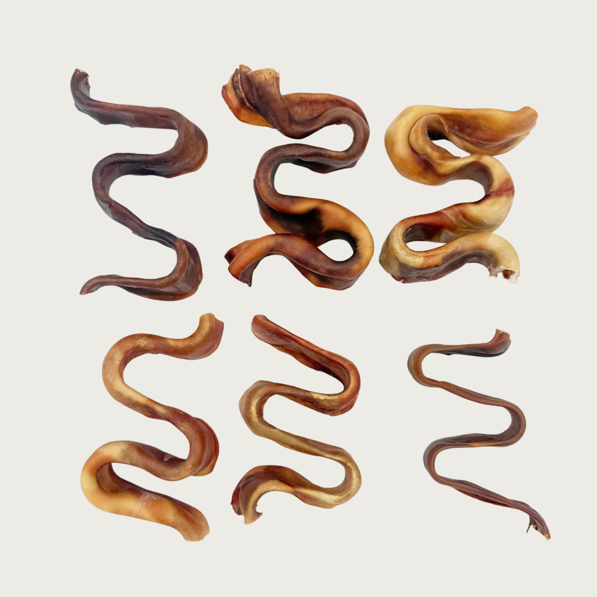 Six Small Wavy Puzzler dog chews arranged in a grid, to show shape & color differences.