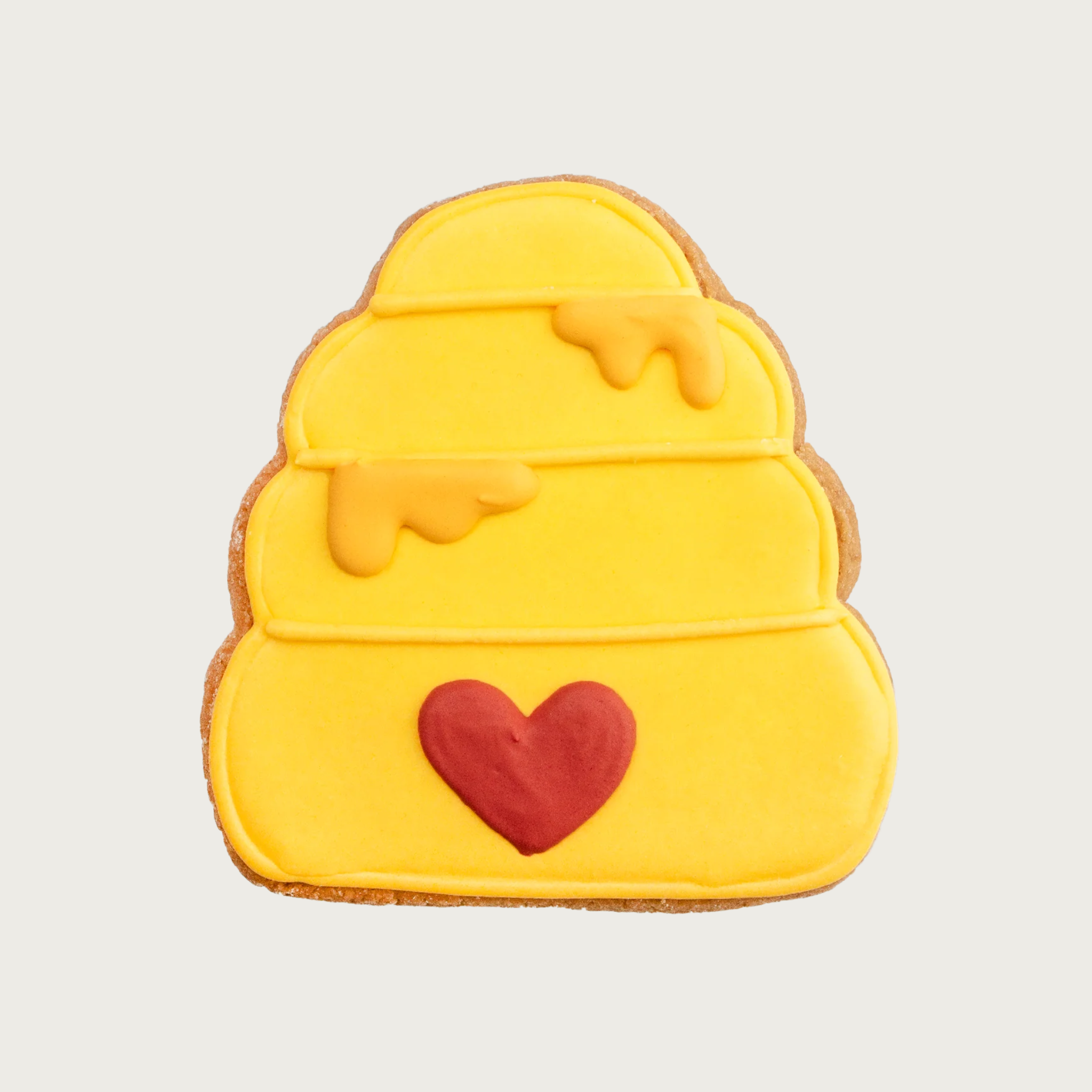 Simply decorated dog cookie that looks like a beehive. It is all yellow with “dripping” honey accents, and a red heart where the opening would be. 