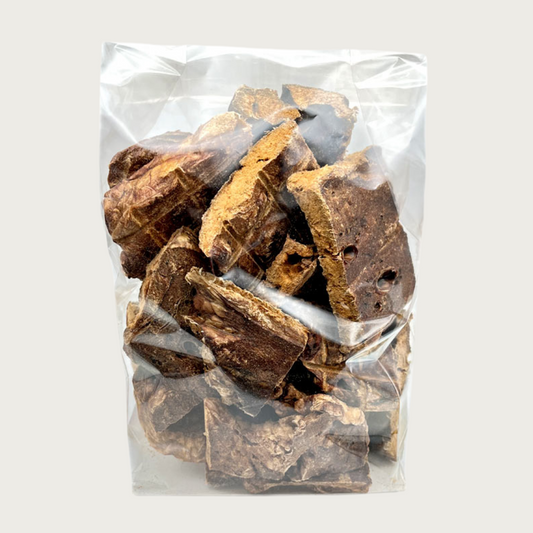 8 oz clear, cellophane bag of Wet Nose Buff Puffs exclusive dog treats. Product inside is visible; large and small square shaped, brown treats.