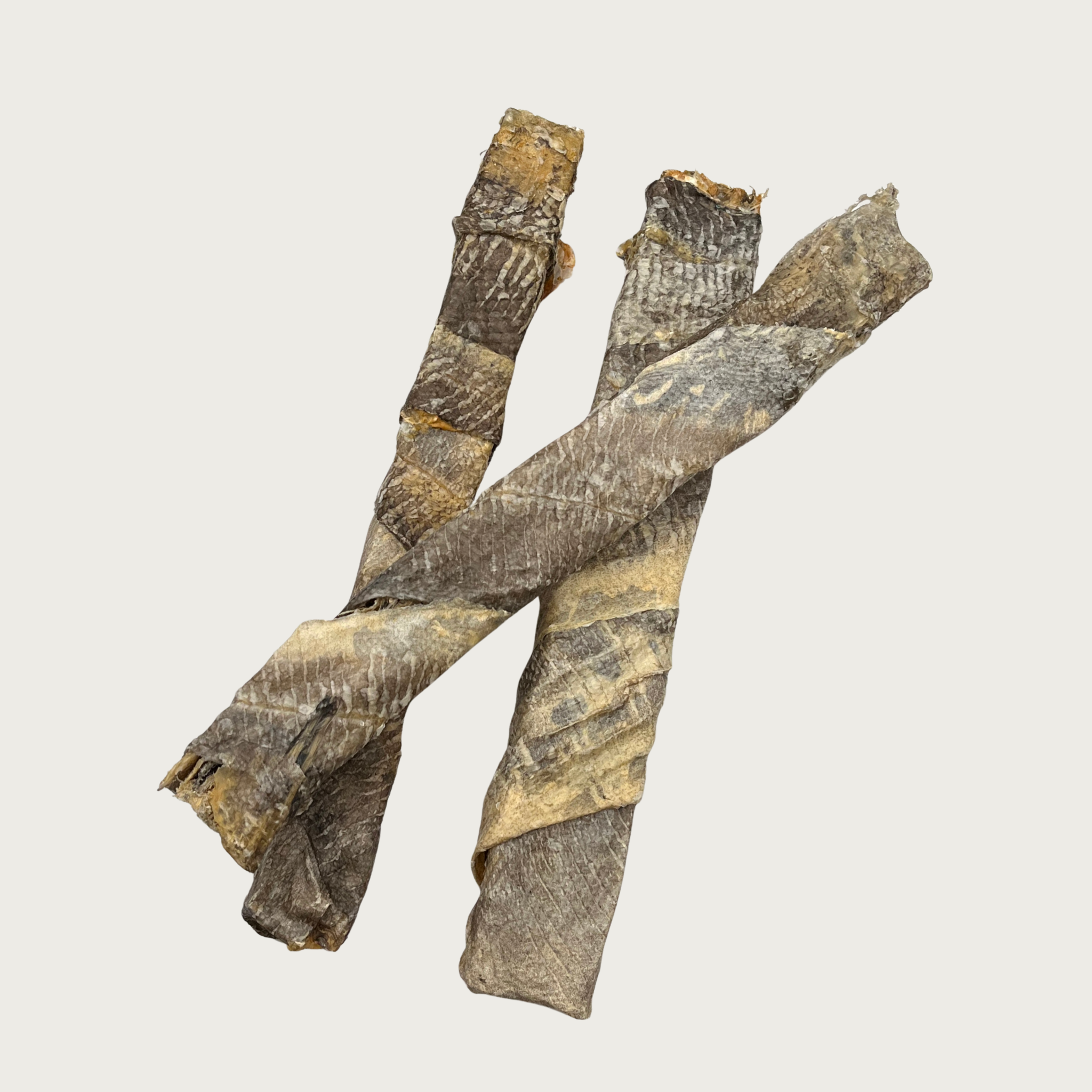 Three Cod Throw Stick dog chews displayed to show slight size & shape variation. The colors are blended shades of gray and tan.