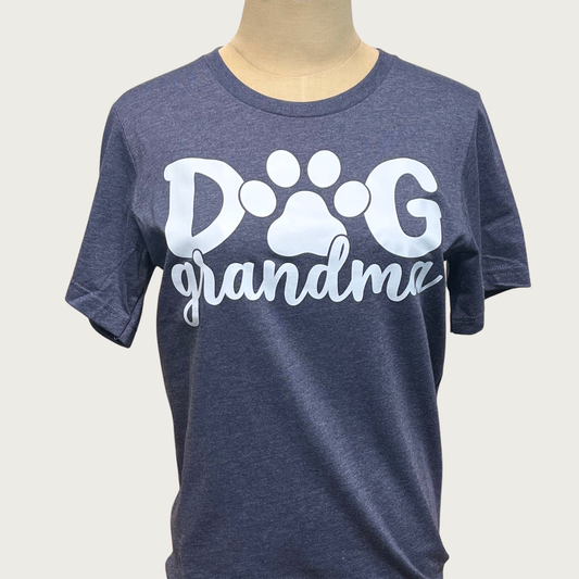 Heathered navy blue t-shirt on a mannequin with white 'Dog Grandma' text in center. "DOG" is in large print with a paw print instead of the "o", "grandma" is beneath in script text.